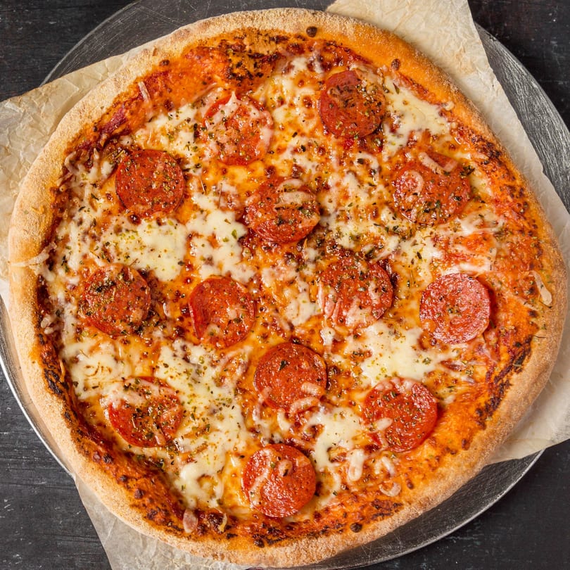 A whole pepperoni pizza from Alberona's Davinci Pizza & Pasta, topped with cheese and herbs.